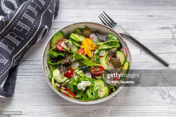 fresh mixed salad with edible flowers - salad tossing stock pictures, royalty-free photos & images