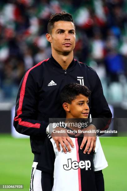 Cristiano Ronaldo of Juventus looks on with his son Cristiano Jr ahead of the Serie A match between Juventus and Atalanta BC at Allianz Stadium on...