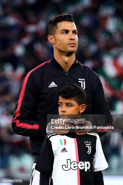 Cristiano Ronaldo of Juventus looks on with his son Cristiano Jr ahead of the Serie A match between Juventus and Atalanta BC at Allianz Stadium on...