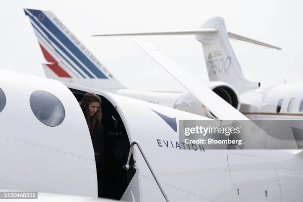 An employee exits an 'Alice' electric aircraft, manufactured by Eviation Aircraft Ltd., during the 53rd International Paris Air Show at Le Bourget,...