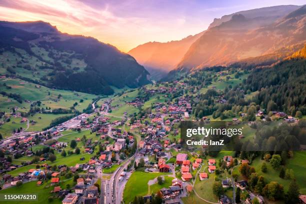 colorful dusk view of grindelwald village valley - eiger mönch jungfrau stock pictures, royalty-free photos & images