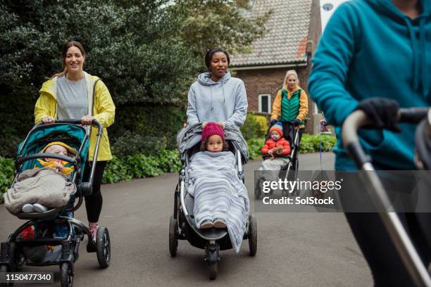 mothers bonding through exercise - mother stroller stock pictures, royalty-free photos & images