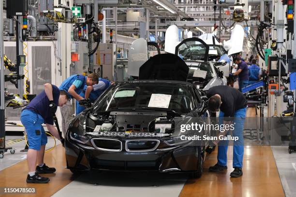 Workers assemble BMW I8 hybrid cars on the assembly line at the BMW factory on May 20, 2019 in Leipzig, Germany. German President Frank-Walter...