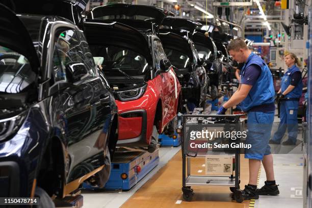 Workers assemble BMW I3 electric cars on the assembly line at the BMW factory on May 20, 2019 in Leipzig, Germany. German President Frank-Walter...