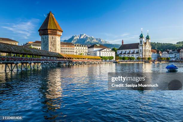 chapel bridge and water tower spanning the reuss river - interlaken ストックフォトと画像