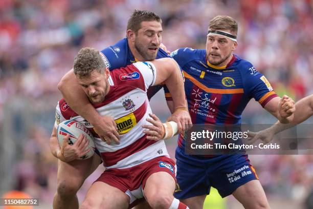 May 18: Sean O"u2019Loughlin of Wigan Warriors is tackled by Julian Bousquet of Catalans Dragons and Remi Casty of Catalans Dragons during the...