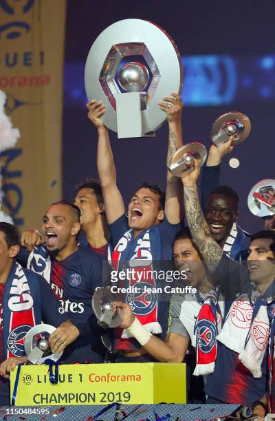 Thiago Silva of PSG - holding the trophy - and teammates celebrate the title of 'French Champion 2019' during the trophy ceremony following the...