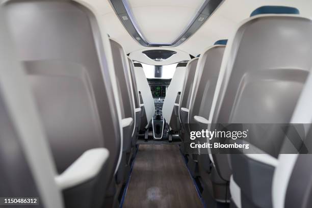 Passenger seats stand behind the open-plan cockpit of an 'Alice' electric aircraft manufactured by Eviation Aircraft Ltd., during the 53rd...