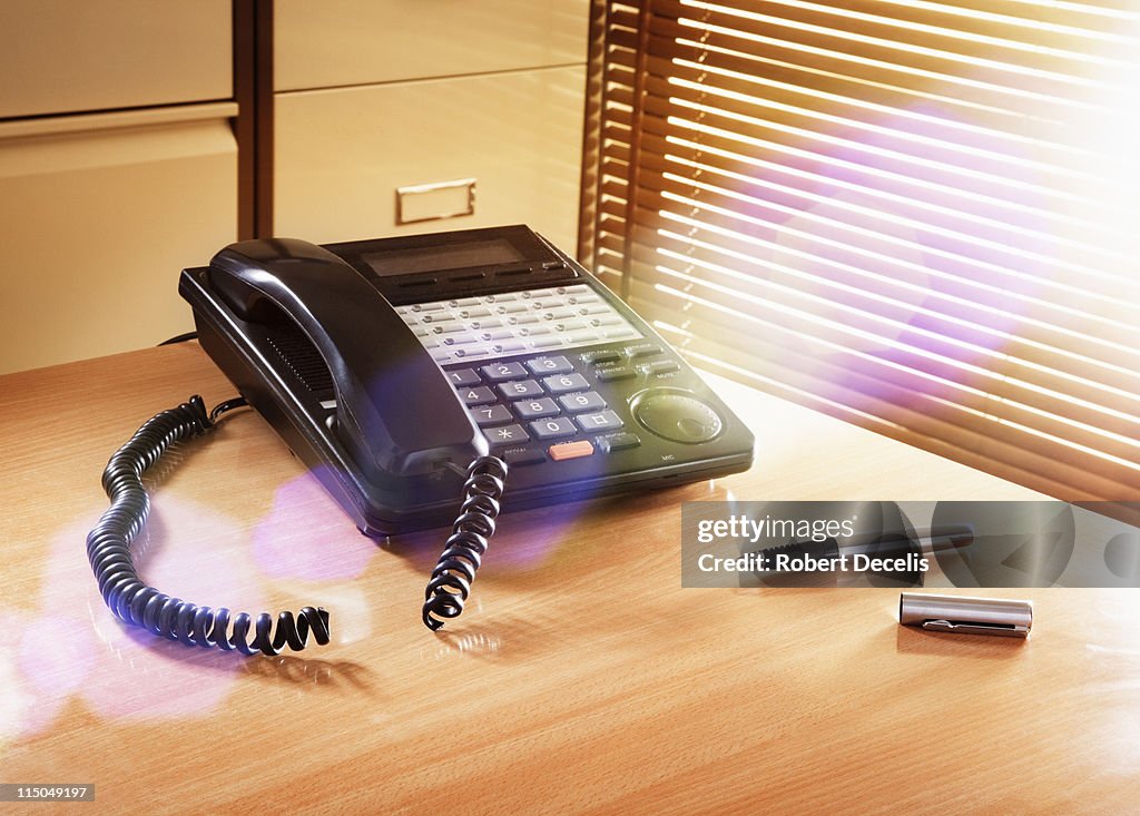 Office telephone with severed cord.