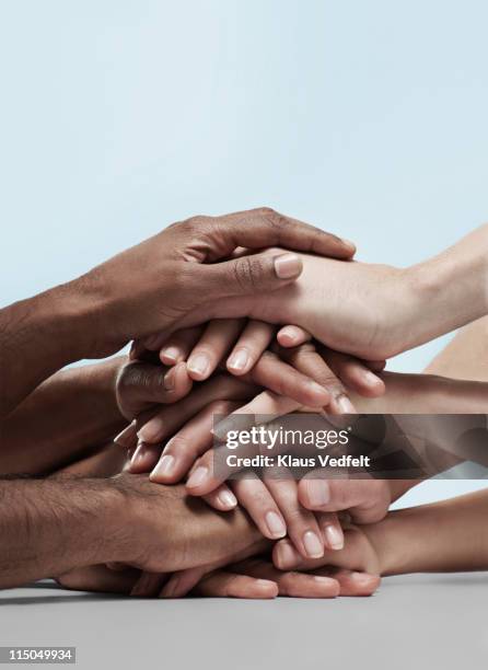 group of people stacking hands on top of eachother - hand stack stock pictures, royalty-free photos & images