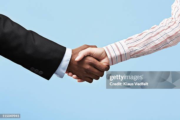 business woman & business man making handshake - sleeve stock-fotos und bilder