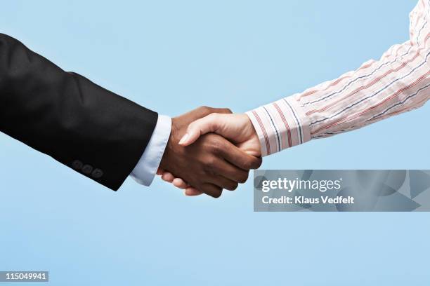 business woman & business man making handshake - hand shake stock pictures, royalty-free photos & images