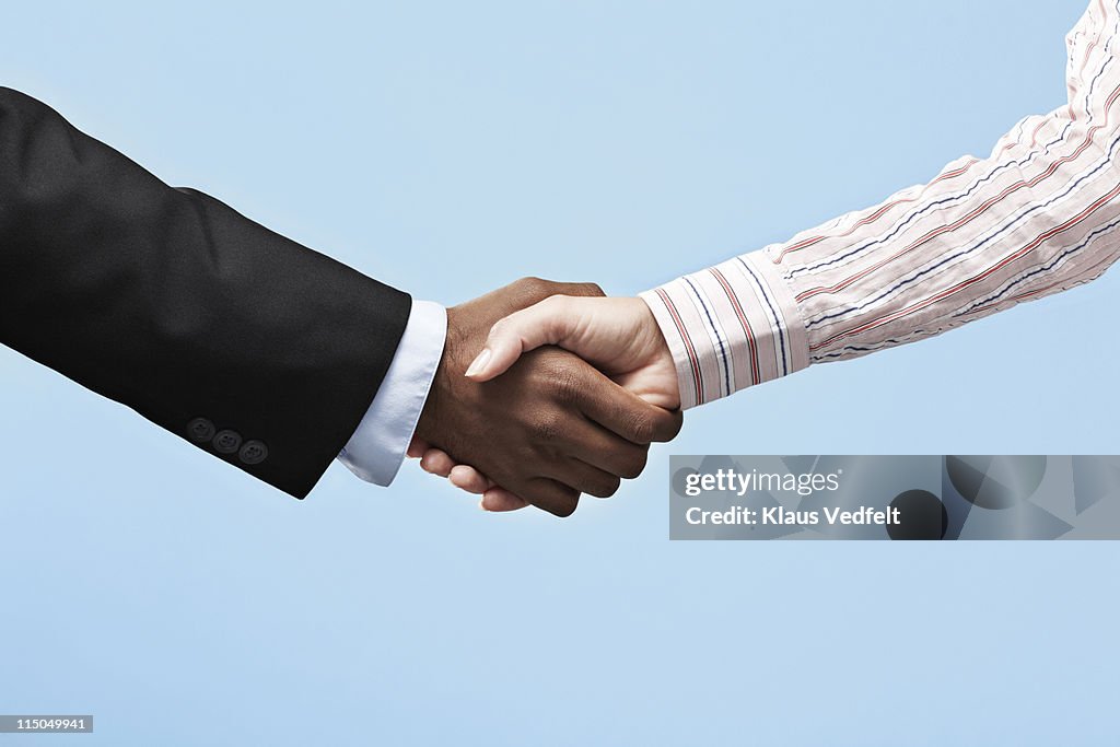Business woman & Business man making handshake