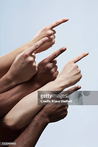 5 pointing fingers of multiple ethnicities - hand pointing stockfoto's en -beelden