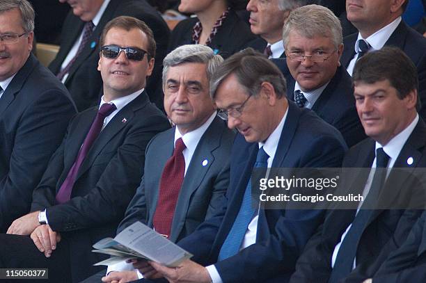 Russian President Dmitry Medvedev , Slovenian President Danilo Turk , and other heads of state attend the military parade to mark the founding of the...