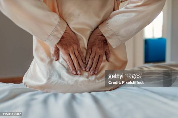 female lower back pain - muscle cramps stock pictures, royalty-free photos & images