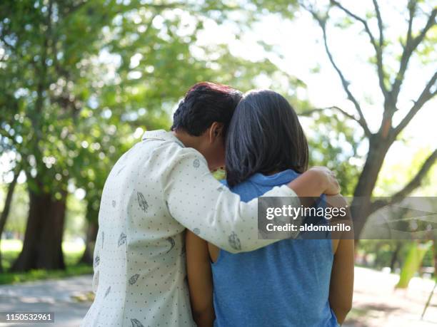 mother comforting teenage daughter - arm around shoulder behind stock pictures, royalty-free photos & images