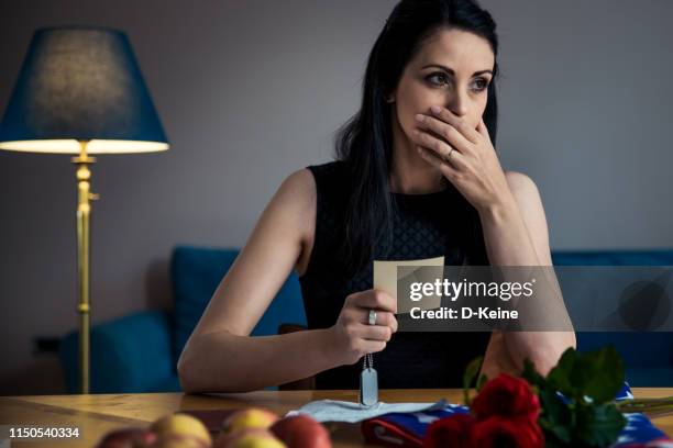 widow holding photograph of his fallen husband - military widow stock pictures, royalty-free photos & images