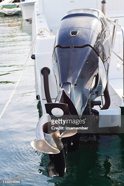 boat engine with propeller attached on motorboat in marina - boat engine stock pictures, royalty-free photos & images