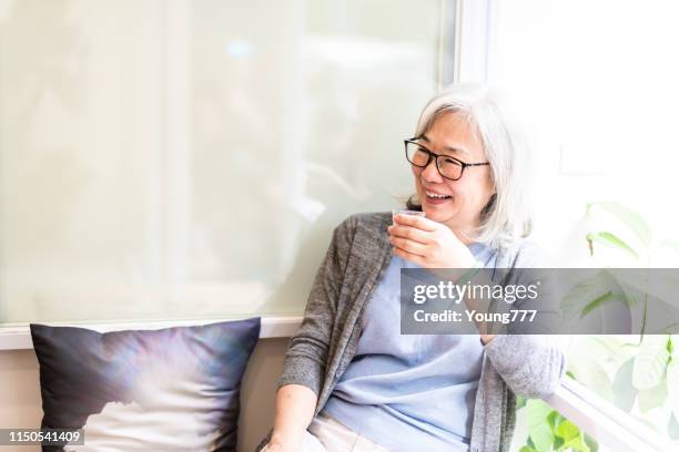 elderly asian woman is drinking tea - taipei tea stock pictures, royalty-free photos & images