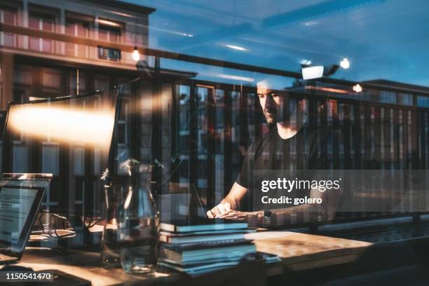 bearded man working late in the office at night - double exposure portrait stock pictures, royalty-free photos & images