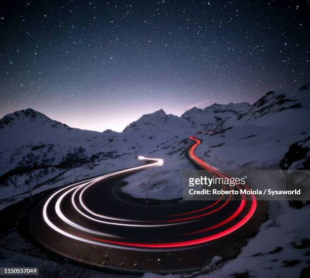 stars on car trails lights, bernina pass, engadin, switzerland - turning imagens e fotografias de stock