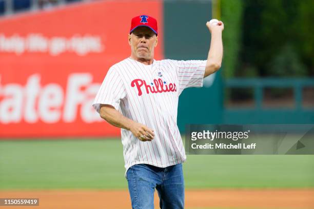 Actor Bruce Willis throws out the first pitch prior to the game between the Milwaukee Brewers and Philadelphia Phillies at Citizens Bank Park on May...