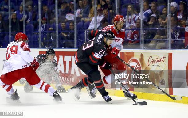 Sam Reinhart of Canada challenges Oliver Lauridsen of Denmark during the 2019 IIHF Ice Hockey World Championship Slovakia group A game between Canada...