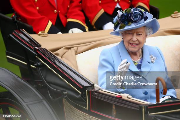 Queen Elizabeth II waves to the crowds as she arrives on day one of Royal Ascot at Ascot Racecourse on June 18, 2019 in Ascot, England.