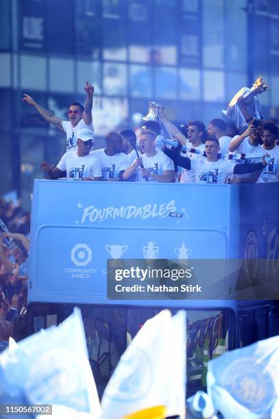 Manchester City players celebrate on a parade bus during the Manchester City Teams Celebration Parade on May 20, 2019 in Manchester, England.