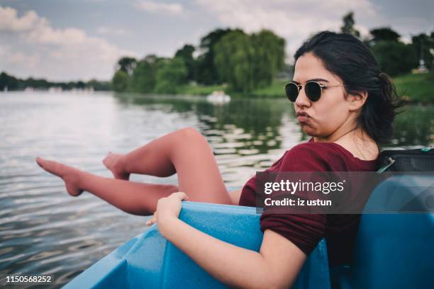 woman puckering on a boat - pedal boat foto e immagini stock