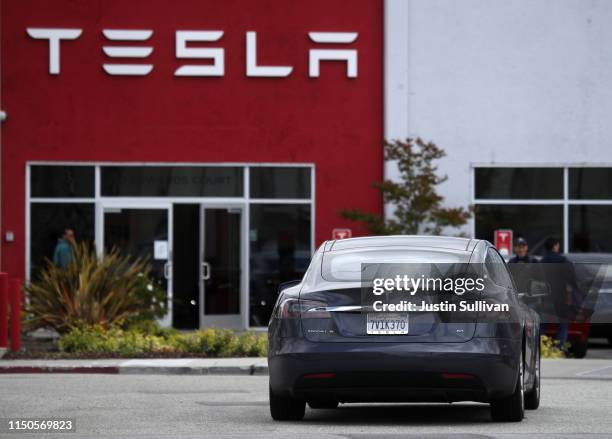 Tesla Model S drives into the parking lot of a Tesla showroom and service center on May 20, 2019 in Burlingame, California. Stock for electric car...