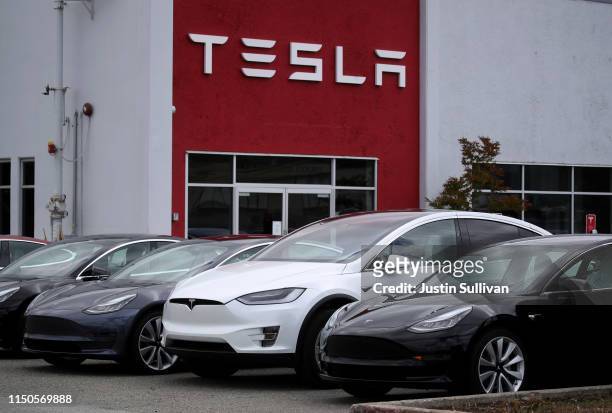 Tesla cars are parked in front of a Tesla showroom and service center on May 20, 2019 in Burlingame, California. Stock for electric car maker Tesla...