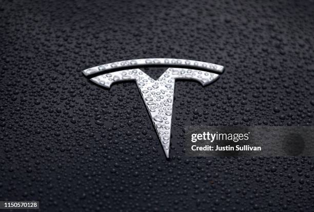 The Tesla logo is displayed on the hood of a Tesla car on May 20, 2019 in Corte Madera, California. Stock for electric car maker Tesla fell to a...