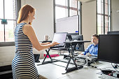 Businesswoman working at ergonomic standing desk