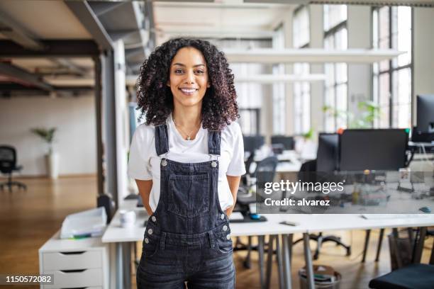 smiling business woman in casuals - dungarees stock pictures, royalty-free photos & images