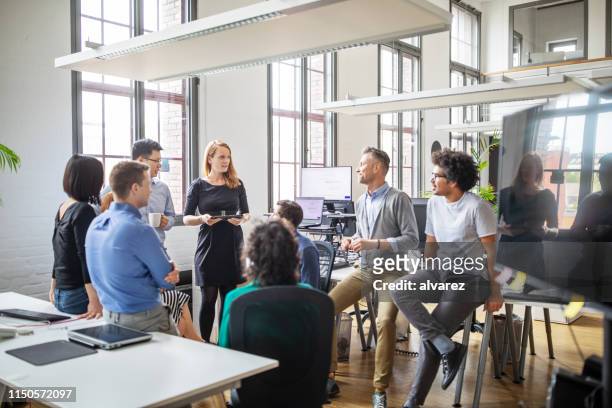 group of professionals discussing new business plan - brainstorming stock pictures, royalty-free photos & images