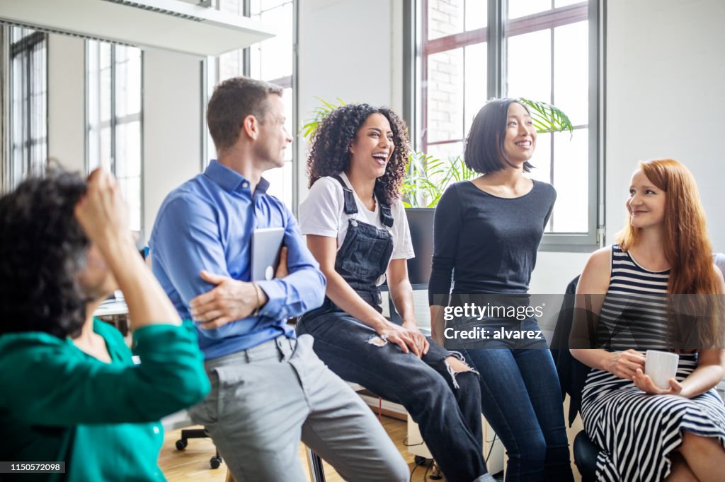 Professionals laughing in a meeting