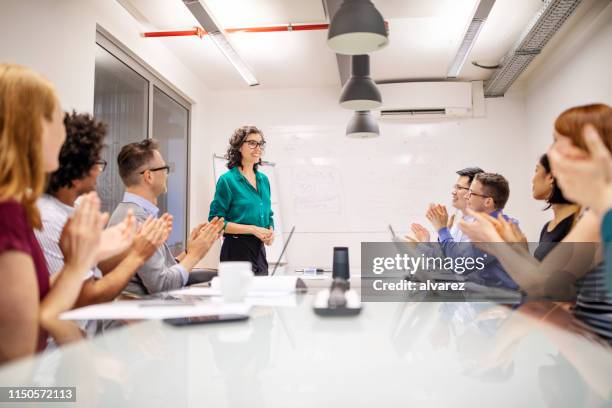 mature businesswoman making a successful presentation - ai speaker stock pictures, royalty-free photos & images