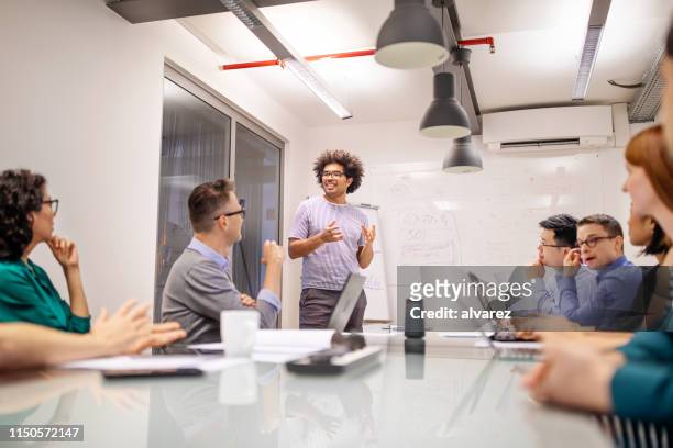 businessman giving presentation in office - ai speaker stock pictures, royalty-free photos & images