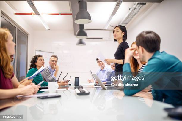 multi-ethnic professionals discussing in meeting - germany womens team presentation stock pictures, royalty-free photos & images