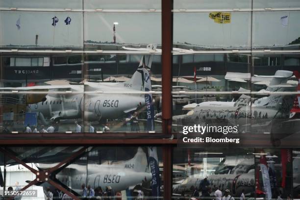 Windows of an exhibition hall reflect some of the static display aircraft during the 53rd International Paris Air Show at Le Bourget, in Paris,...