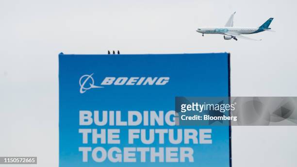 An Airbus SE A330Neo passenger aircraft flies above the Boeing Co. Exhibition areaduring the 53rd International Paris Air Show at Le Bourget in...