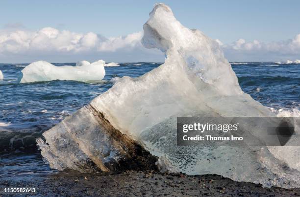 Small iceberg laying on the Black Sand Beach pictured on March 30, 2019 in Joekulsarlon , Iceland.