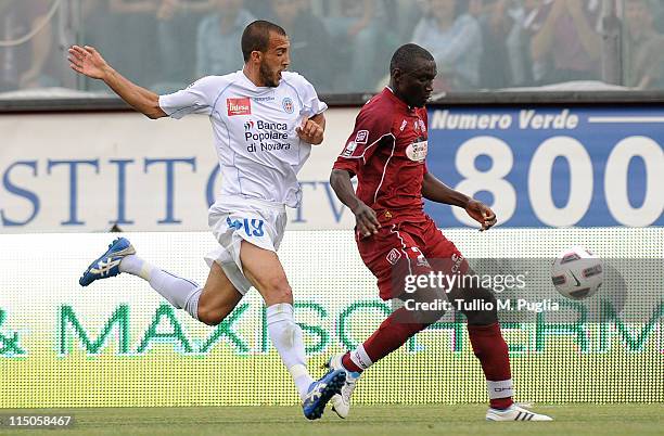 Daniel Adejo of Reggina holds off the challenged by Pablo Andres Gonzalez of Novare during the Serie B playoff match between Reggina Calcio and...