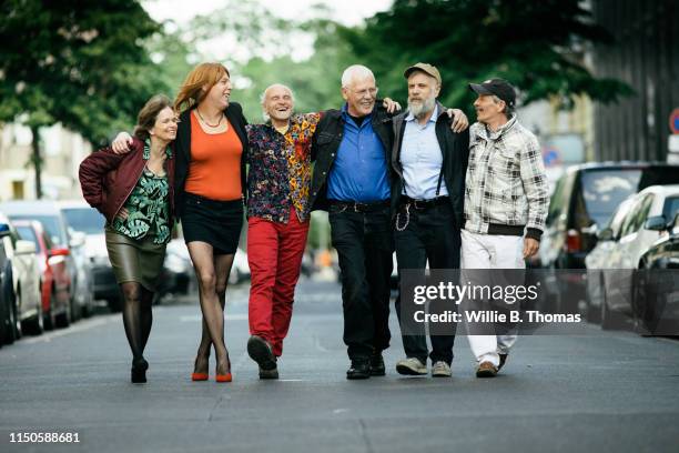 group of senior and middel age queer people - group of friends walking along street fotografías e imágenes de stock