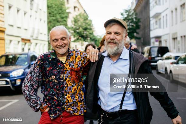 senior gay men walking together - gay seniors fotografías e imágenes de stock
