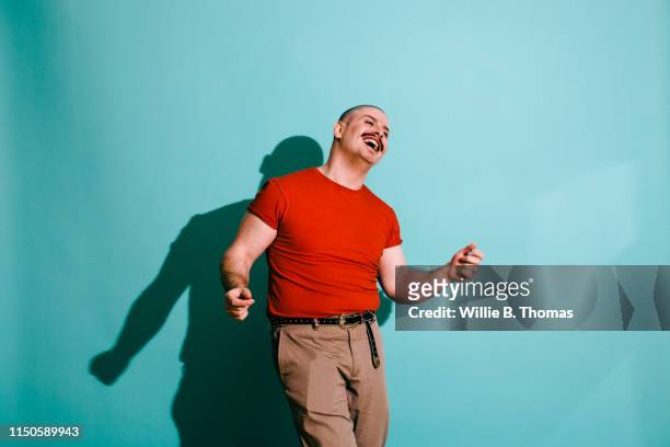vibrance portrait of man dancing - gay person stockfoto's en -beelden