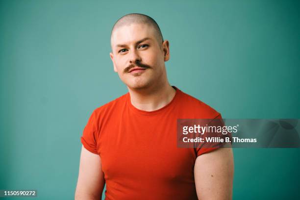portraits of gay man - studio portrait colour background stock-fotos und bilder