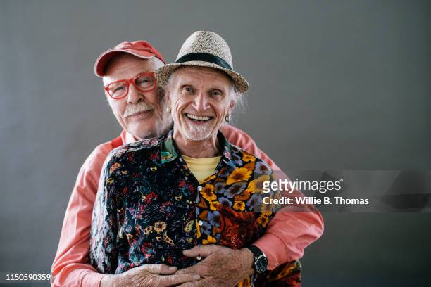 studio portrait of senior gay couple - couples studio portrait stock-fotos und bilder